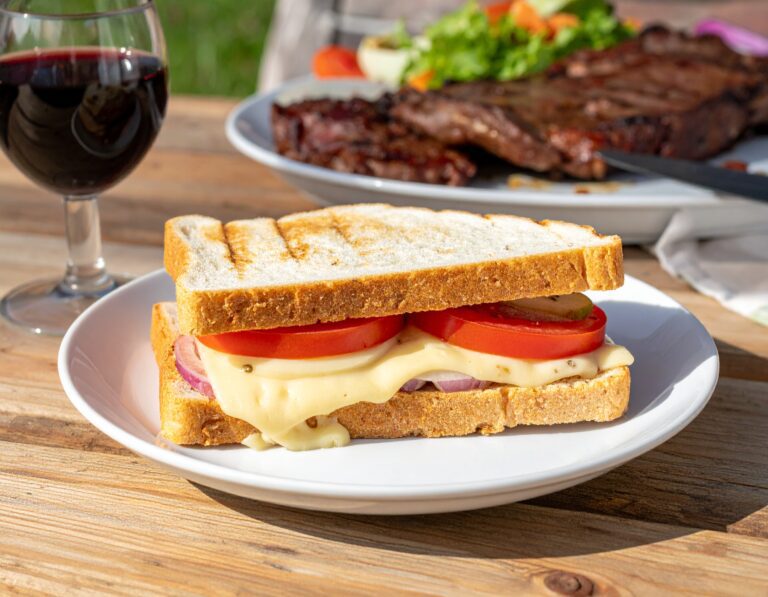 Firefly a realistic photo of a Cheese and tomato and onion closed braai sandwich on white bread slic